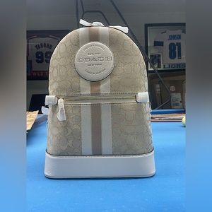 Tan, cream, and brown backpack with 2 zippers